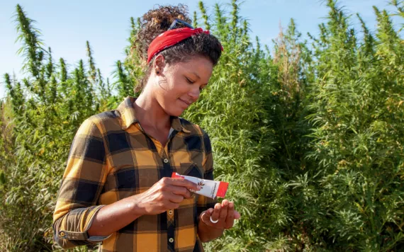 Hemp farmer Shani Coleman pours a pack of Patagonia Provisions Organic Savory Seeds into her hand.