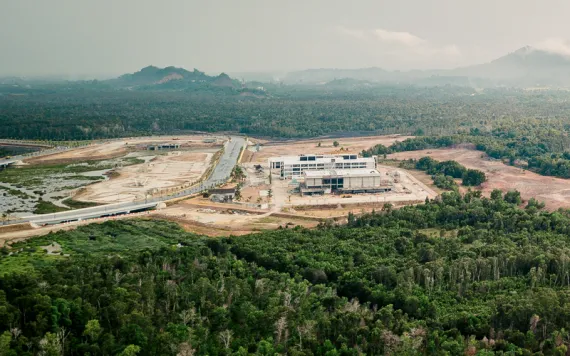 A rail construction site sits in the middle of lush, green peatlands.