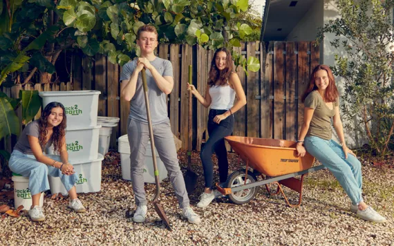 Anna, Ugo, Emma, and Mila Angeletti pose with Back2earth bins, a shovel, and a wheelbarrow.