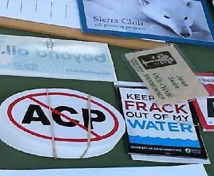 A close-up of stickers and handouts on a table at a protest against the Atlantic Coast Pipeline