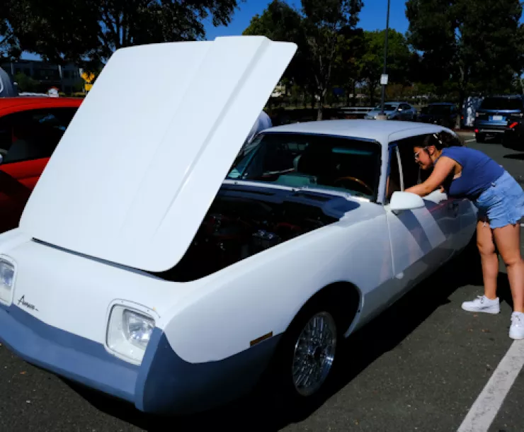 Student checks out an EV