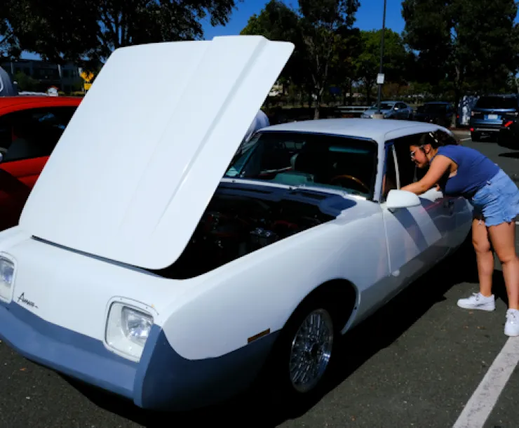 Student checks out an EV