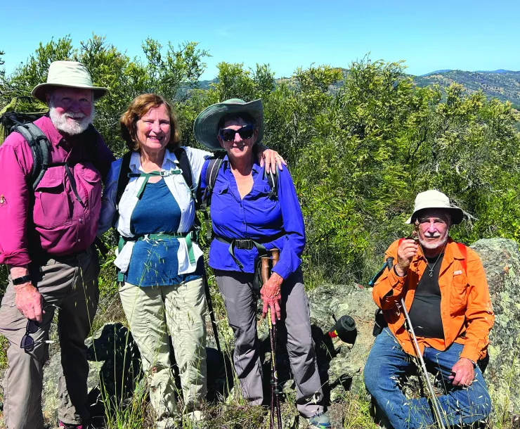 Ralph Alcorn, Susan Alcorn, Patricia Schaffarczyk, Tom Coroneos stand atop a peak. Photo by David Sanger Photography.