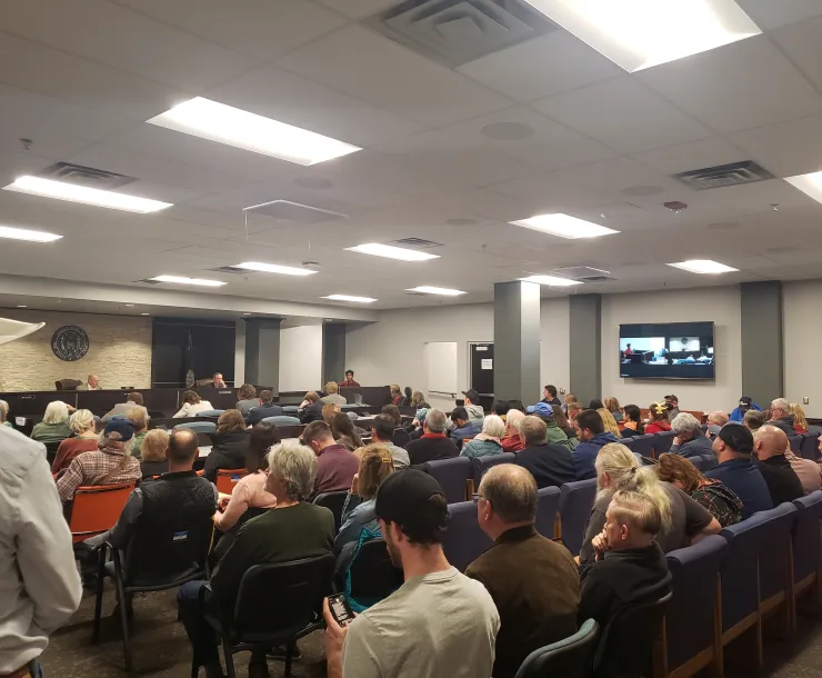 Picture of dozens of people sitting in a hearing room