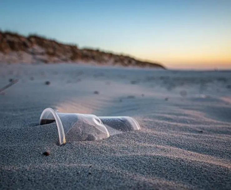 Plastic trash in sand at the beach