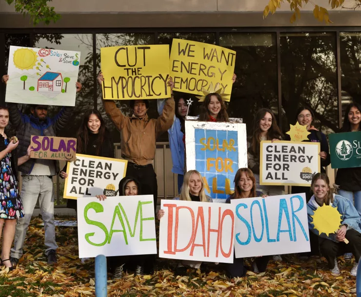 student activists holding up signs in support of solar democracy