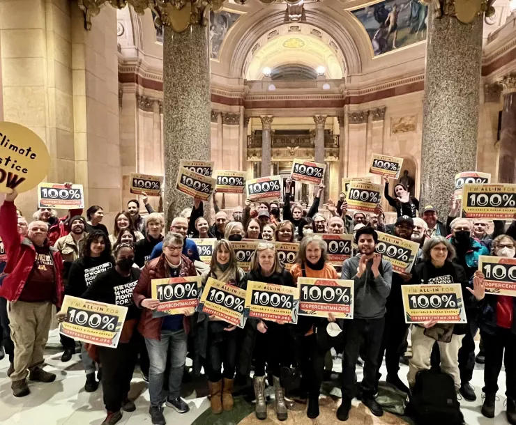 Activists celebrate the passage of 100% Clean Energy bill inside the Minnesota Capitol