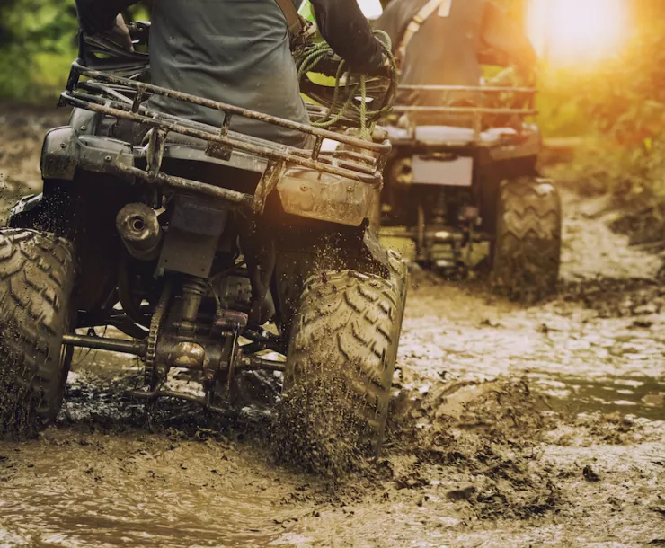 Photo of ATVs crossing a muddy creek. Photo by suriya silsaksom/iStock