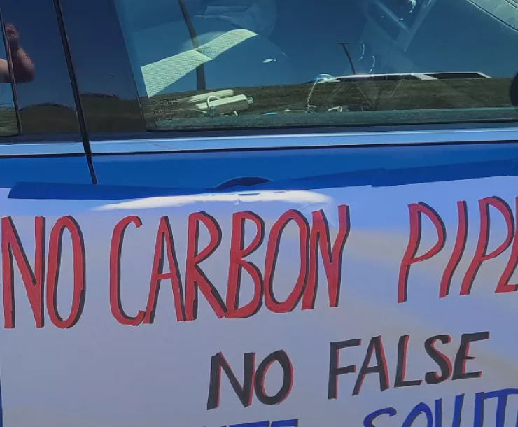 Photo of "No Carbon Pipelines" sign on the side of a car. Credit: Iowa Sierra Club
