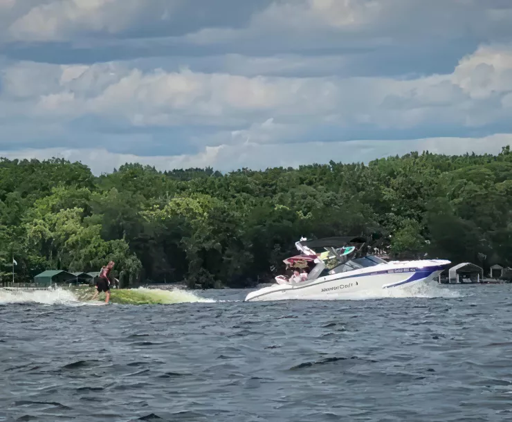 A wake boat in action on a lake