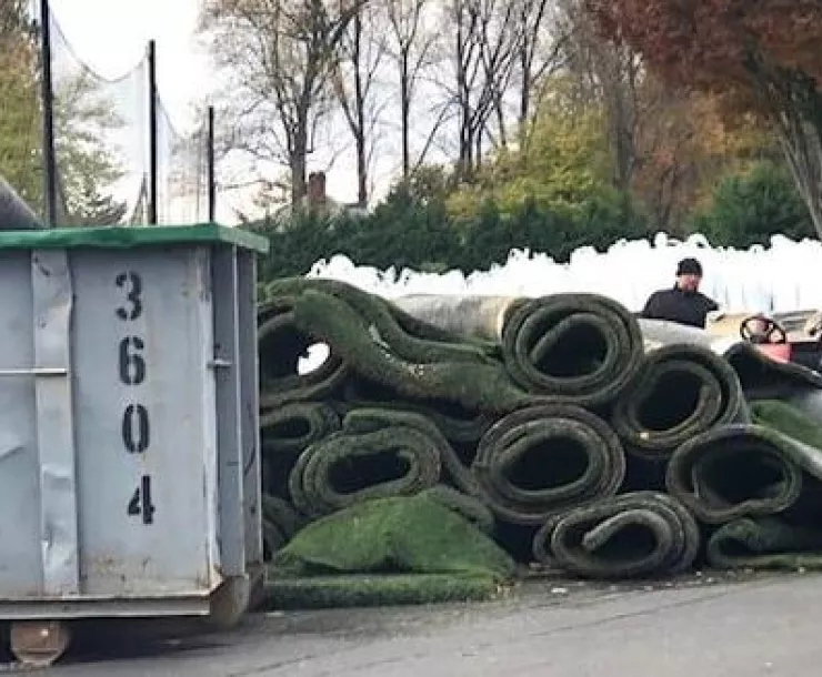 Rolled turf next to a dumpster