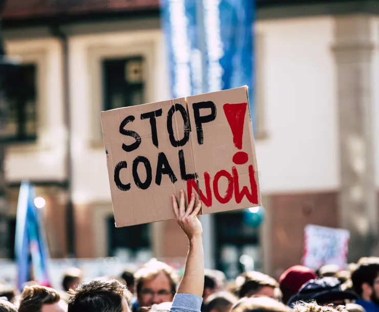 protesters with stop coal now sign