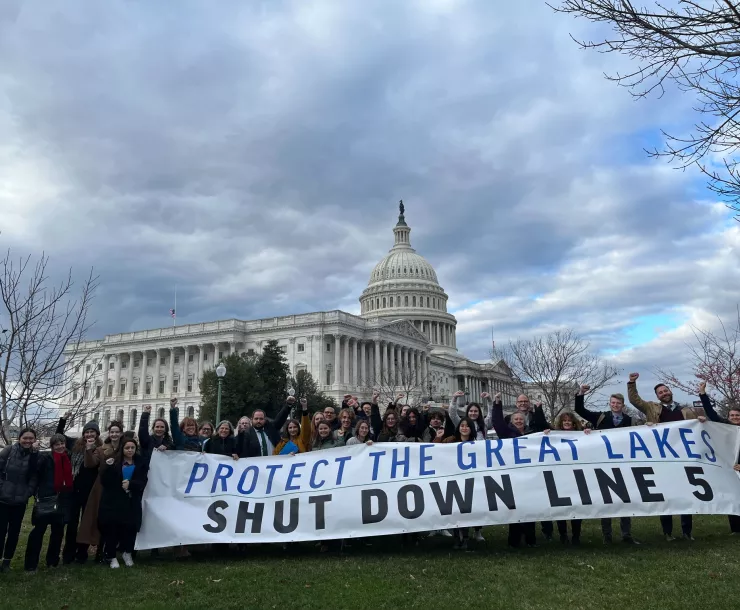 DC attendees holding Shut Down Line 5 sign