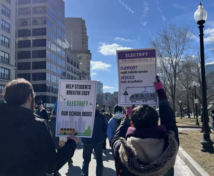 People holding signs at the Transit Equity Day rally