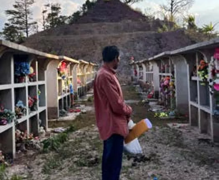A community leader from Azacualpa looks at the relocated ancestral cemetery that the mining company Aura Minerals destroyed. Photo credit: Minnesota Center for Environmental Advocacy