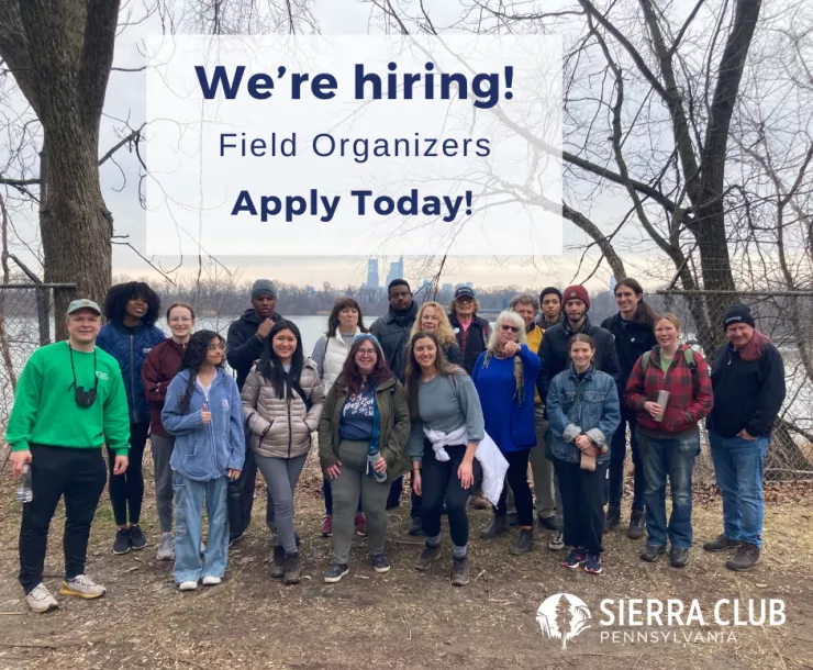 A diverse group of hikers pose for a photo in front of a reservoir surrounded by trees. Navy text announces, "We're hiring! Field Organizers Apply Torday!" with Sierra Club Pennsylvania's logo at the bottom.