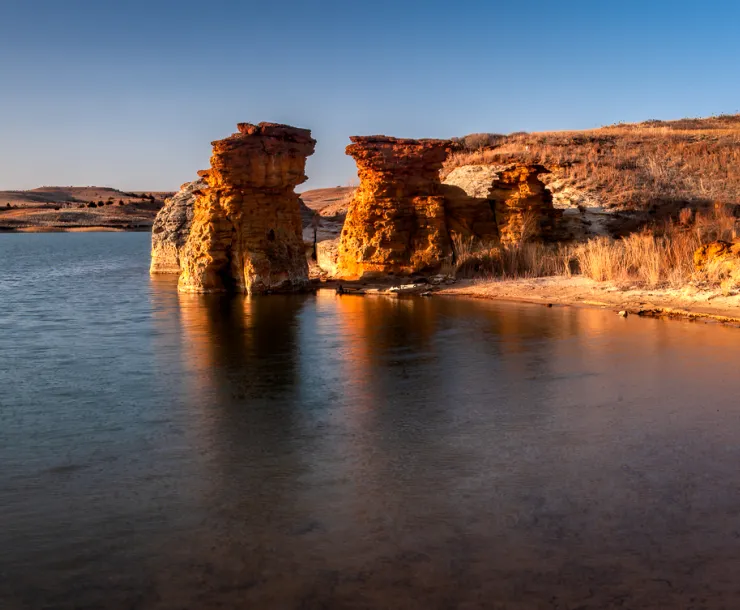 blue lake and sky surrounded by big rock formations