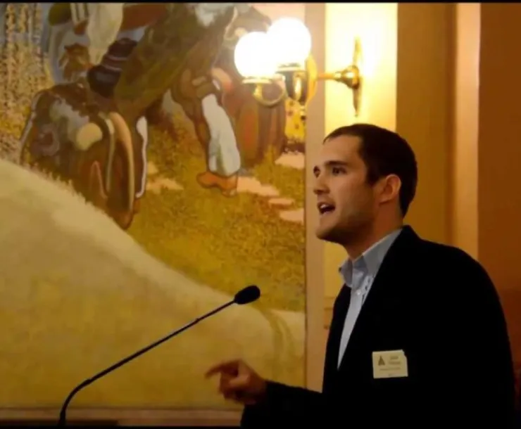 man in front of microphone in Kansas capitol