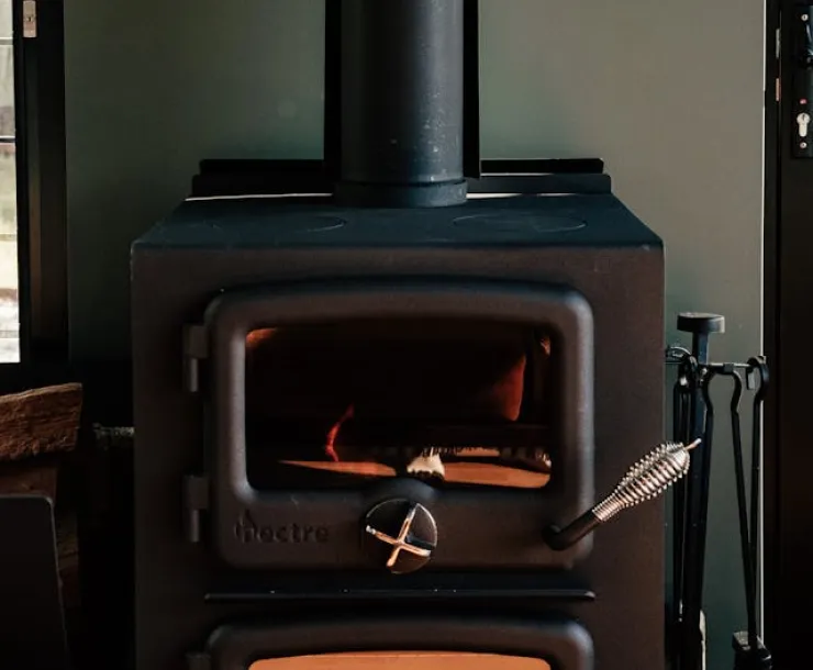 Wood stove. Photo by Rachel Claire: https://www.pexels.com/photo/photo-of-a-fireplace-8112294/