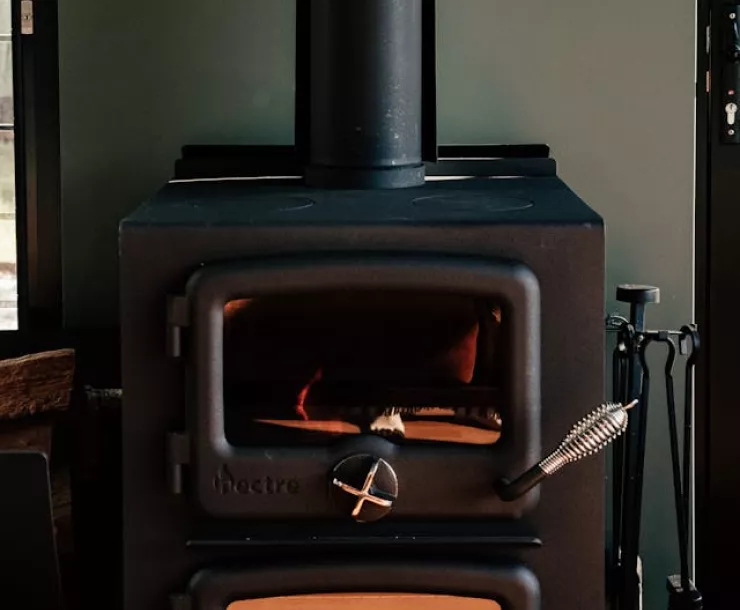 Wood stove. Photo by Rachel Claire: https://www.pexels.com/photo/photo-of-a-fireplace-8112294/