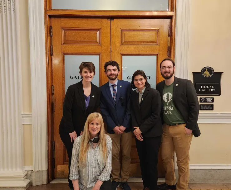 Chapter staff and volunteers standing and smiling in front of a room labeled "House Gallery"