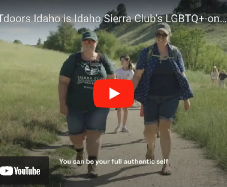 Screenshot of video on You Tube, two women holding hands on hike