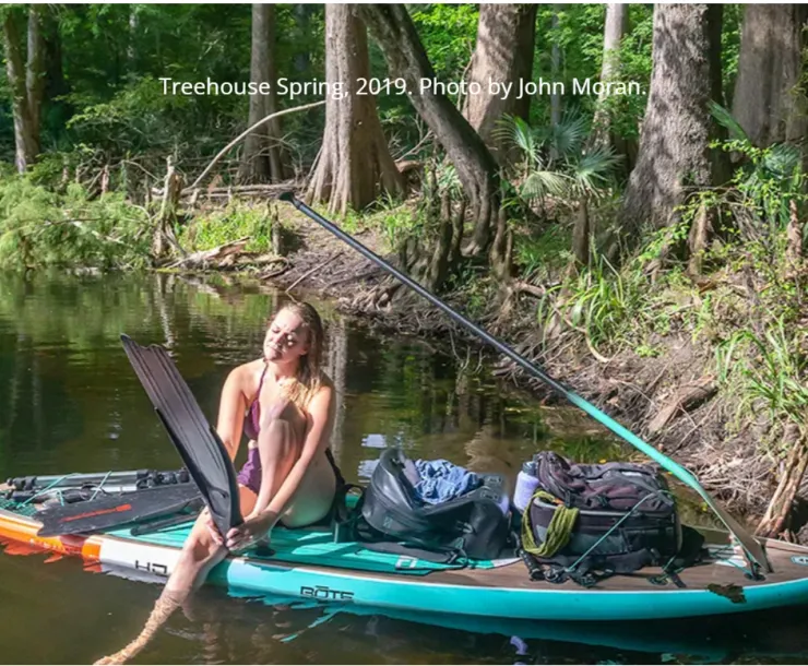 A snorkler prepares to get in the water at Treehouse Springs
