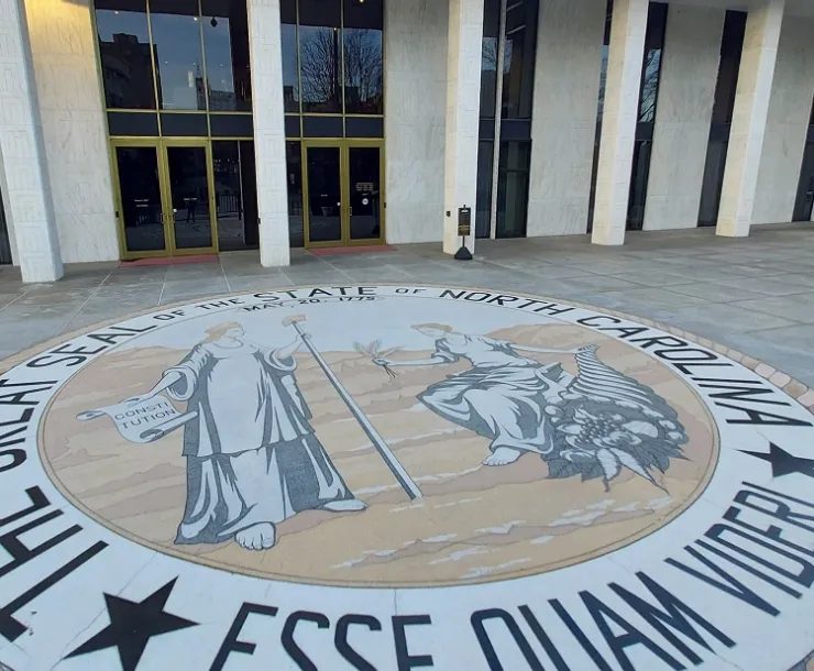 The state seal of North Carolina on the walkway outside the Legislative Building