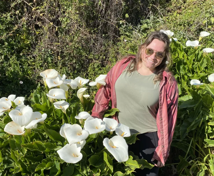 Erika stands amongst lilies