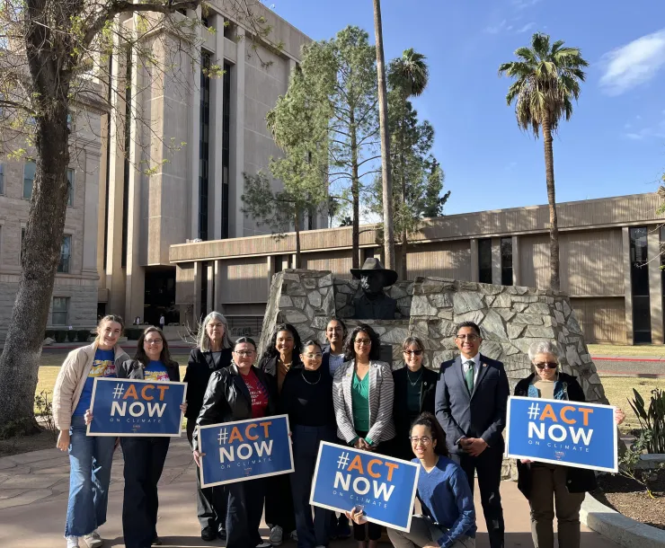 A group of activists holding blue signs