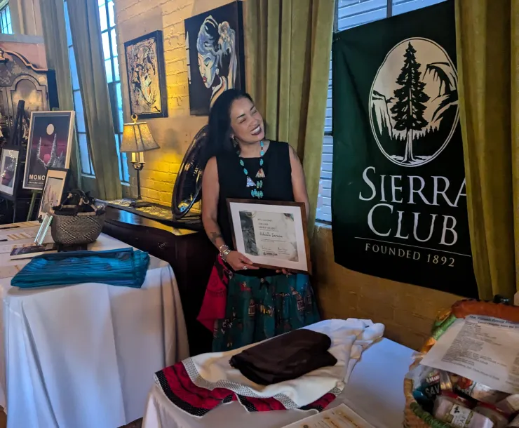 Staff member Adelita Serena receiving an award