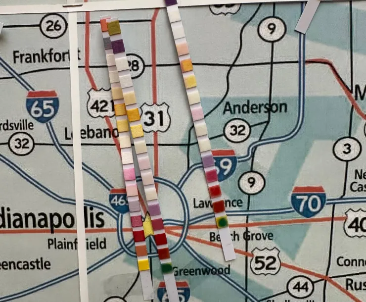 Water testing strips on a map of Indiana. The strips show blocks of different colors to indicate water quality