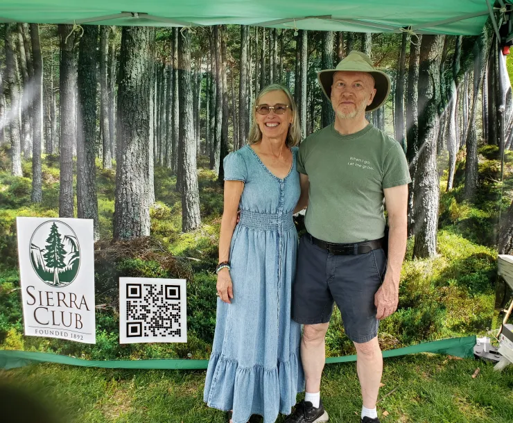Regina Beck and John McFadden model in front of the Forest Photo Op