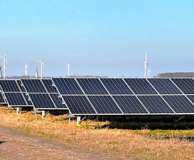 The Amazon East wind farm in eastern NC is shown in the distance, with a solar farm in the foreground.