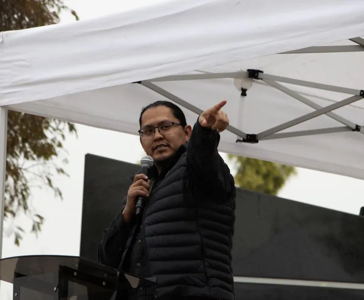 a person giving a speech and pointing 