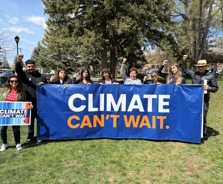 a group of people holding a large blue banner