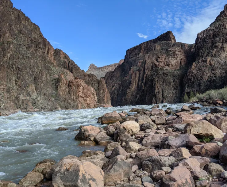 a white water rapid in a deep canyon