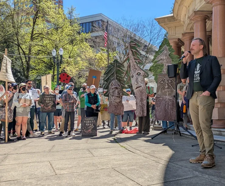 A photo of a large rally crowd outside Portland City Hall in the sunshine