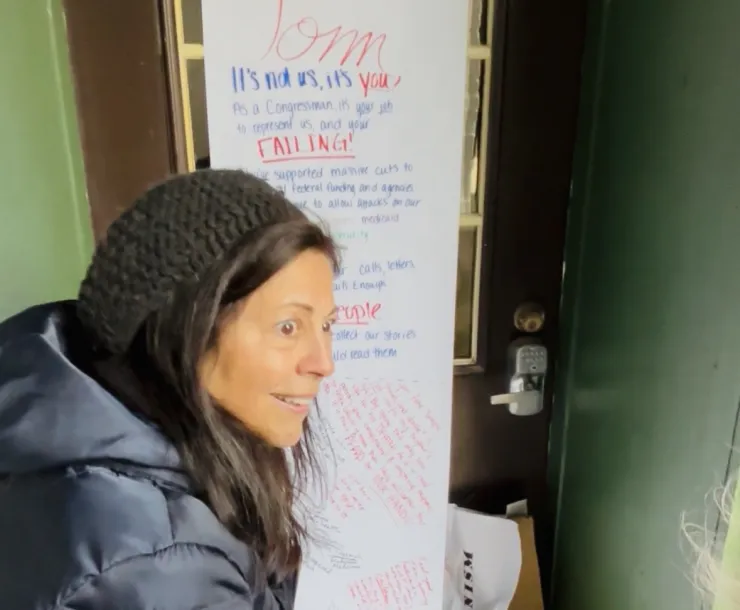 A protester tacks a long letter to Rep Barrett to his office door