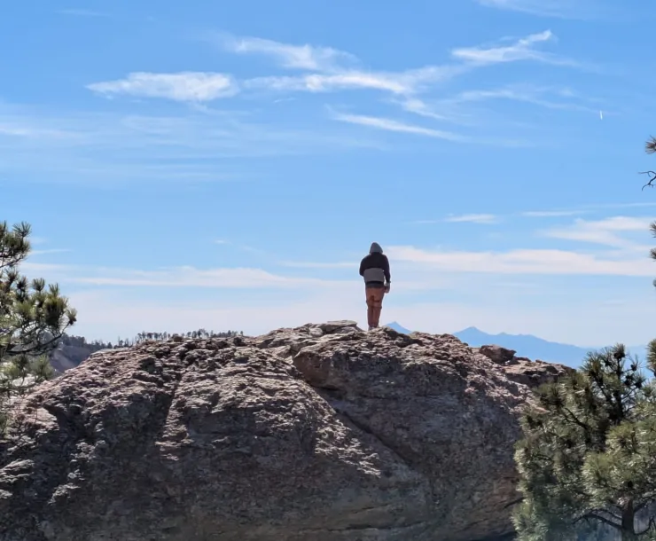 a person standing on a large boulder 