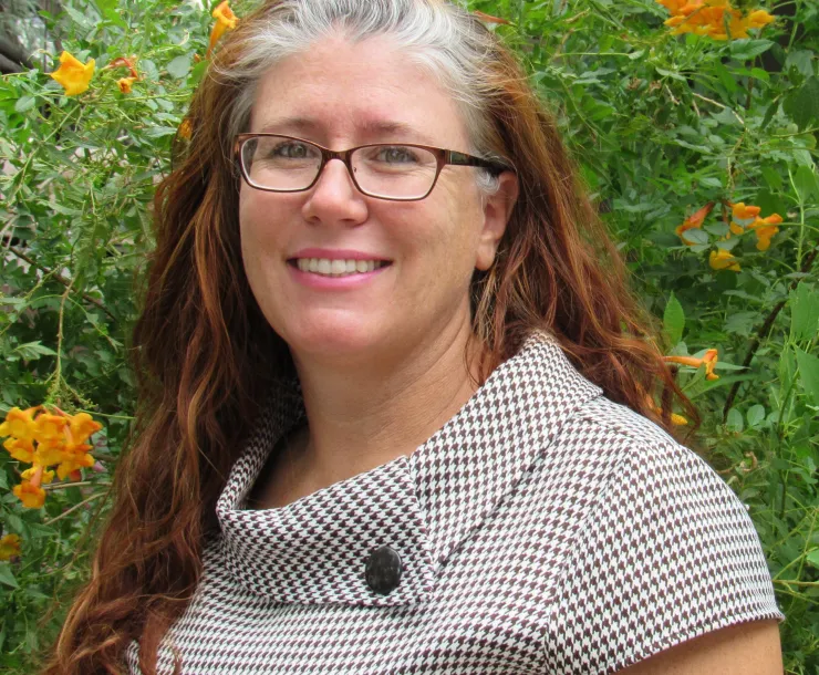 a person in front of a green lush background