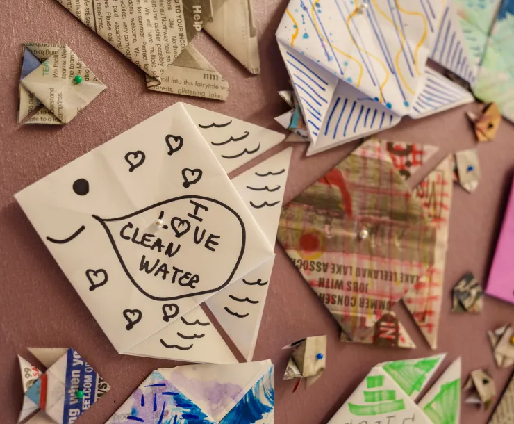 paper fish pinned to the board with one that says "I love clean water"