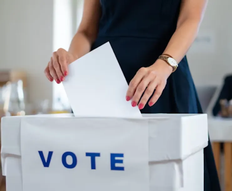 A person turning in their ballot