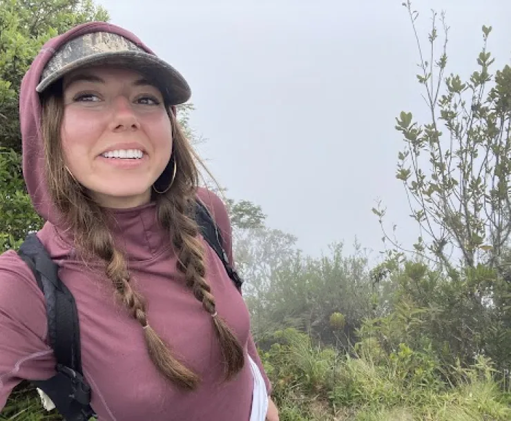 a person taking a selfie in a lush green area outdoors