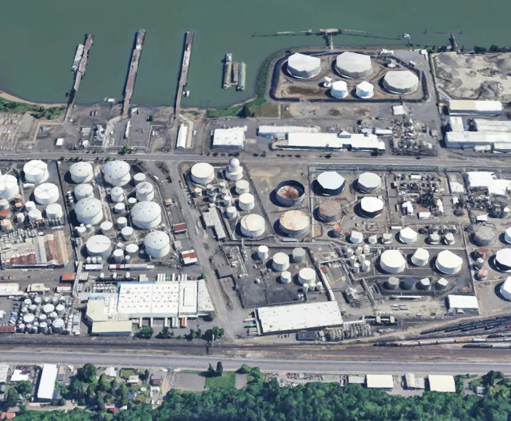 An aerial view of the Critical Energy Infrastructure Hub, a sprawling compound of hundreds of fuel tanks along the Willamette River.