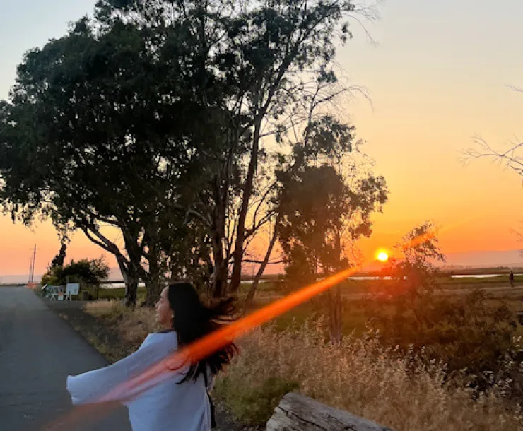 Woman in wetlands at sunset