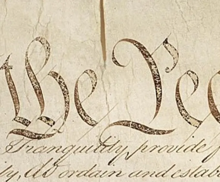The first lines of the US Constitution, "We the People," seen in close-up