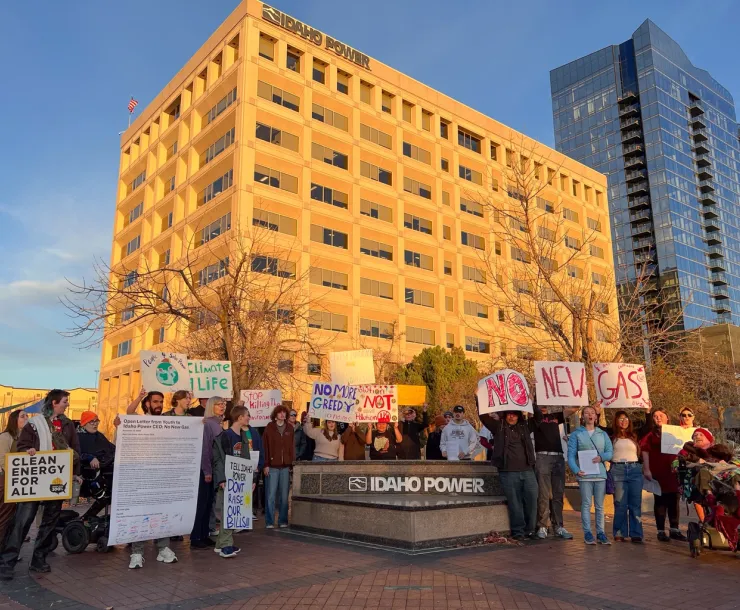 Picture of young people holding signs that say No New Gas in front of Idaho Power's headquarters building