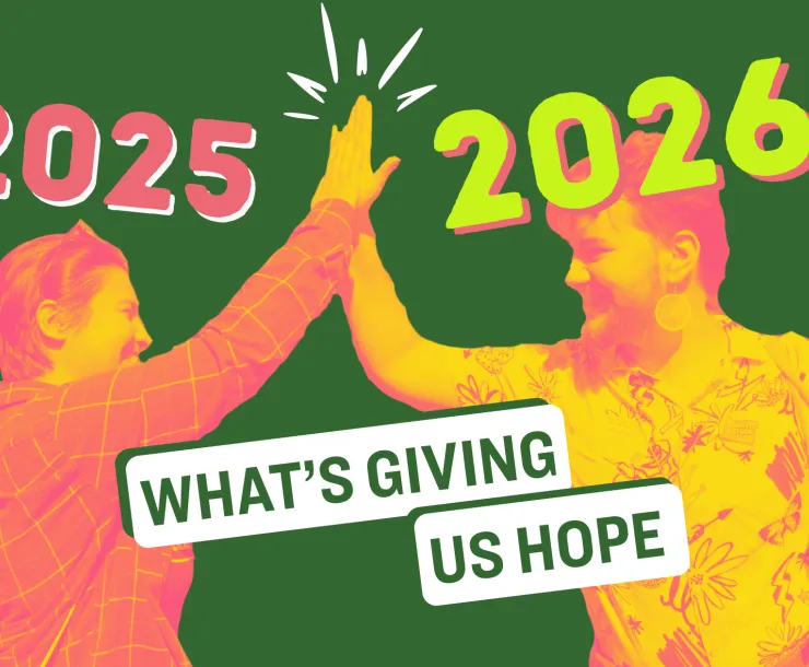 A photo of two young people high-fiving