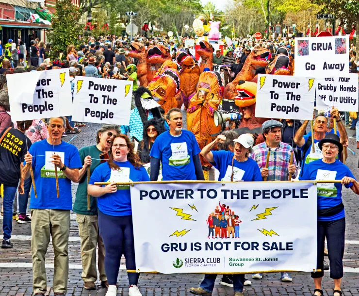 Photo of protesters carrying signs saying Power to the People 